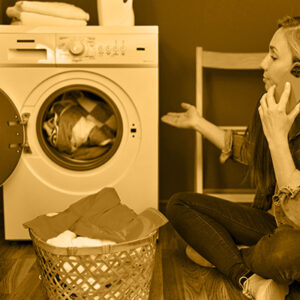 woman with broken washing machine on the phone with support